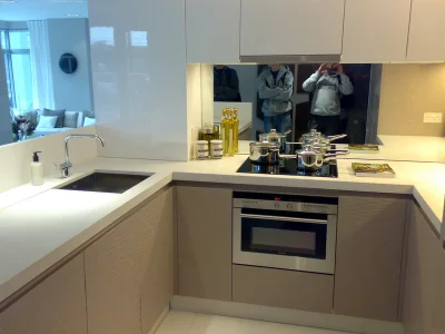 bespoke kitchen cabinets and drawers with sink and mirror
