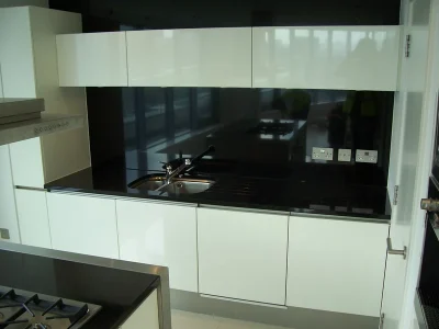 modern black and white kitchen with sink and sockets