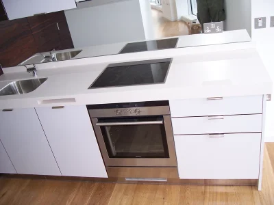 white neat kitchen with fitted cabinets