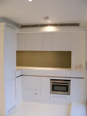 white kitchen furniture with lighting on the ceiling