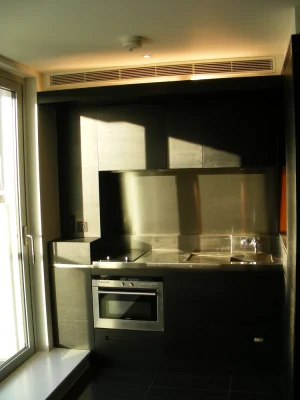 black kitchen with fitted cabinets and closed doors