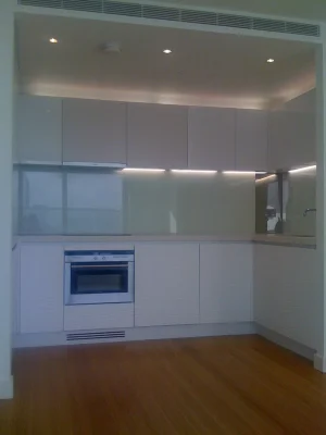 white neat kitchen with bespoke furnitures with visible floor panels
