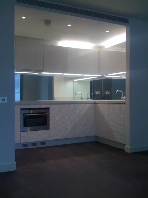 white kitchen with mirrors and sink
