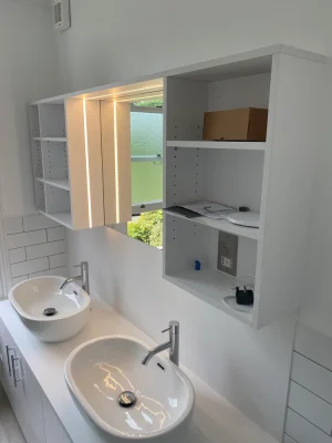 two sinks with fitted shelves in the bathroom