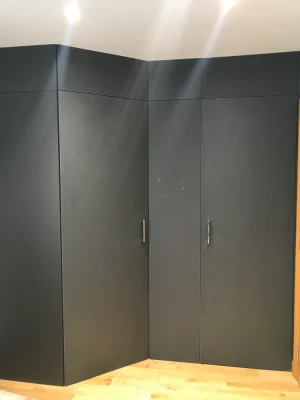 black bespoke wardrobe with lighting above it
